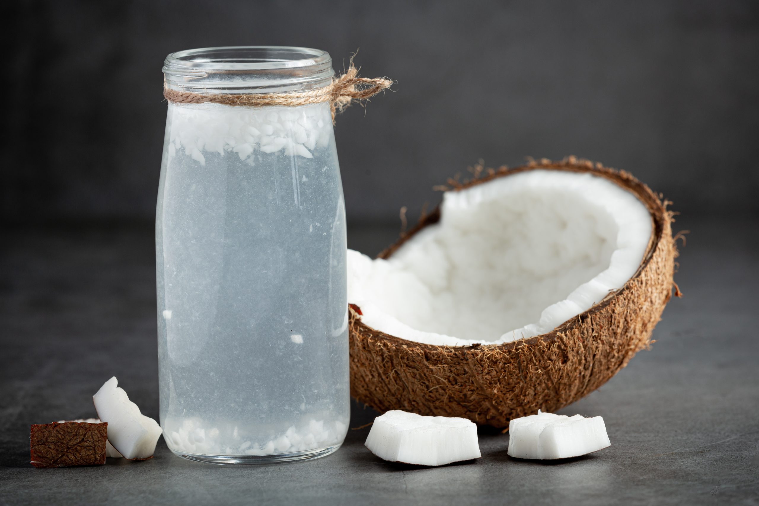 a bottle of coconut water put on dark background